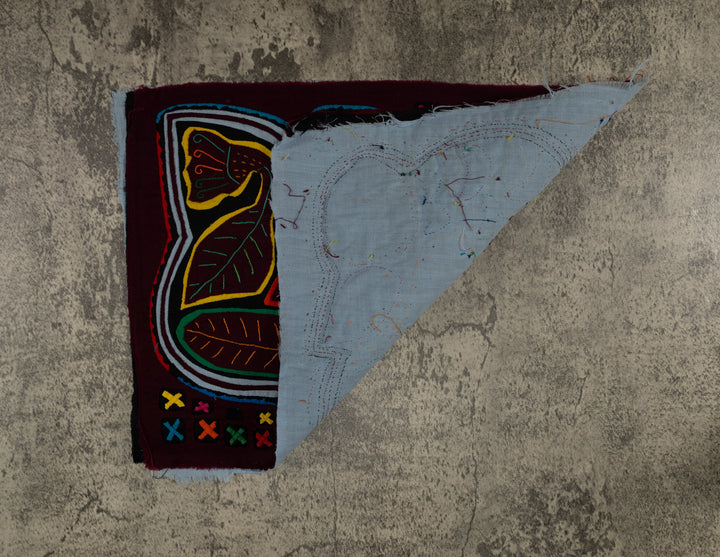 Hand stitched Guna mola from Guna Yala Panama, gray and white outline winding around the design