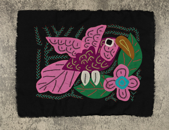 Panama molita, a pink volcano hummingbird by a blue flower on black, hand stitched reverse applique