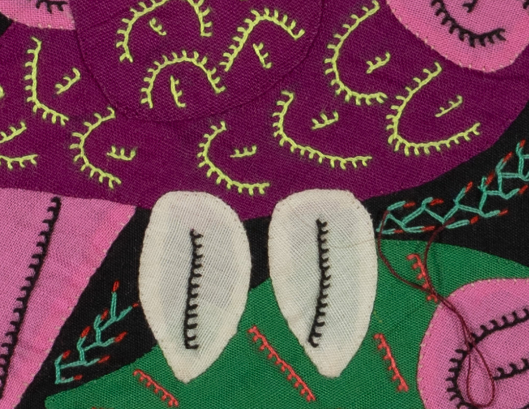 Panama molita, a pink volcano hummingbird by a blue flower on black, hand stitched reverse applique