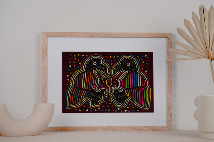 Burgundy Bird Playing Footsie Mola
