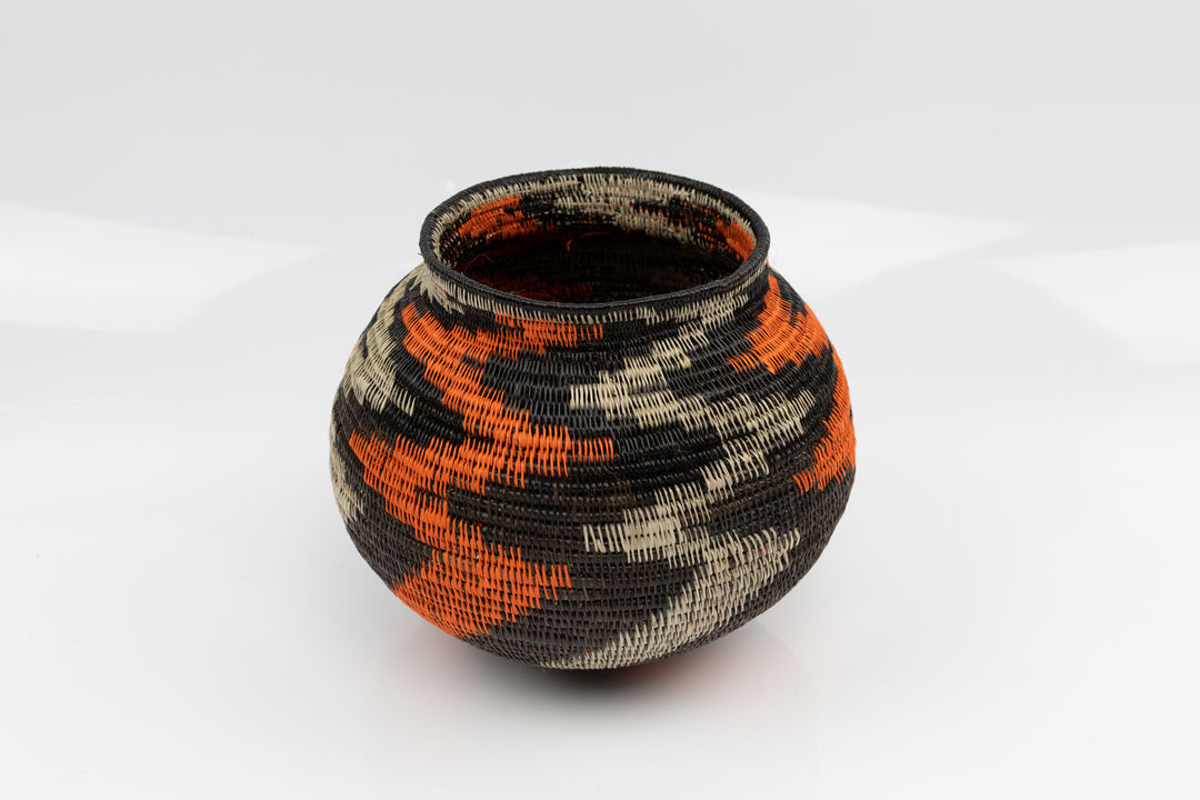 Panama Hand woven black and orange basket. palm fiber. natural dyes.