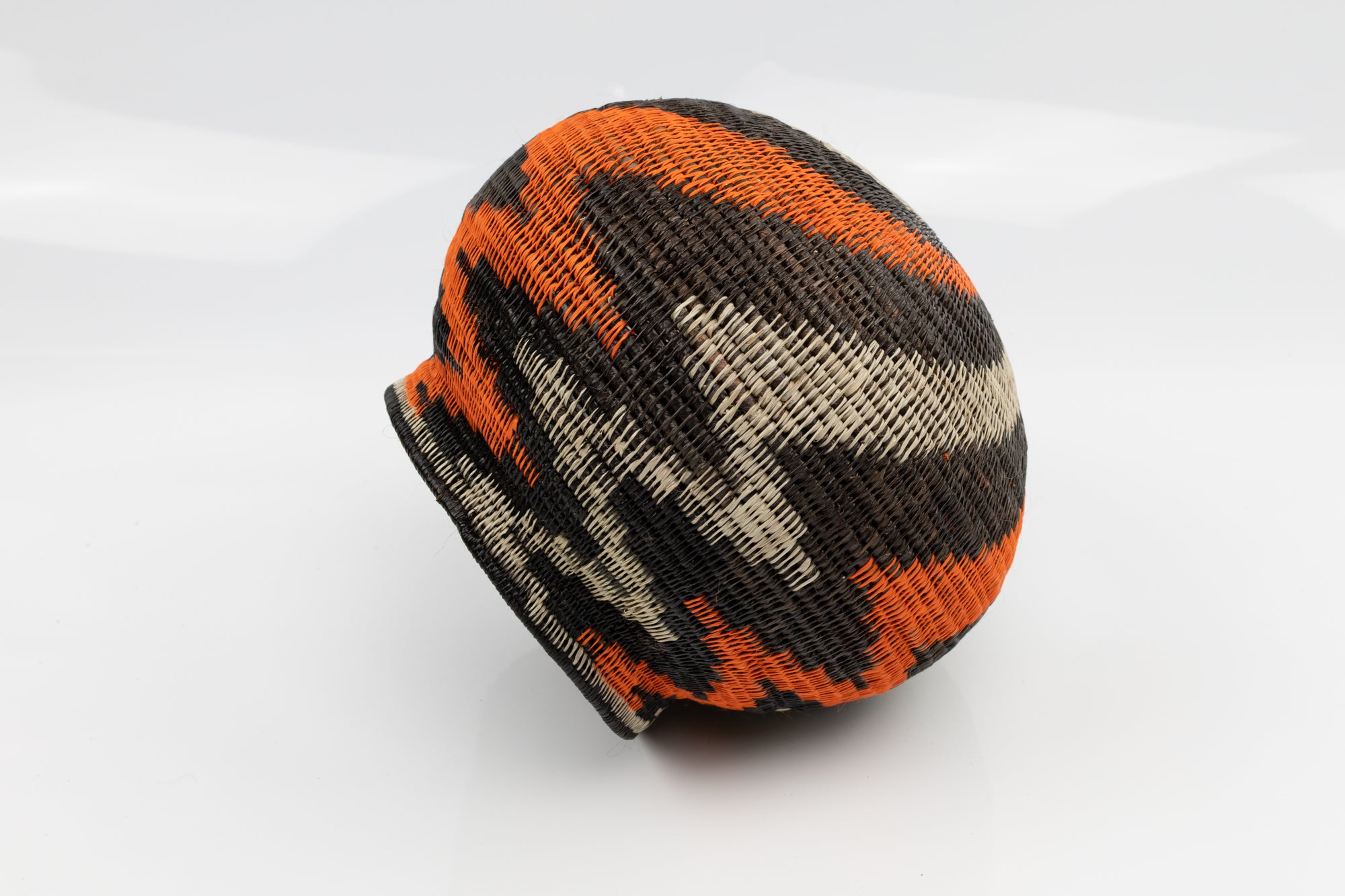Panama Hand woven black and orange basket. palm fiber. natural dyes.