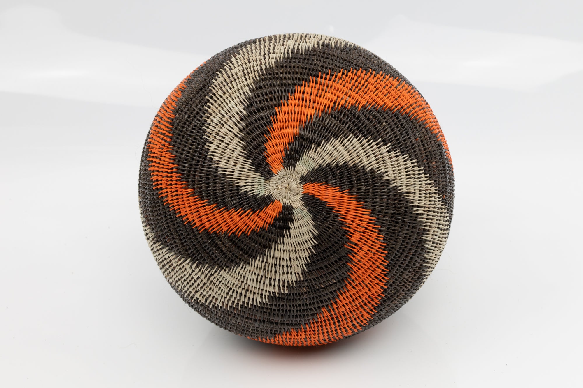 Panama Hand woven black and orange basket. palm fiber. natural dyes.