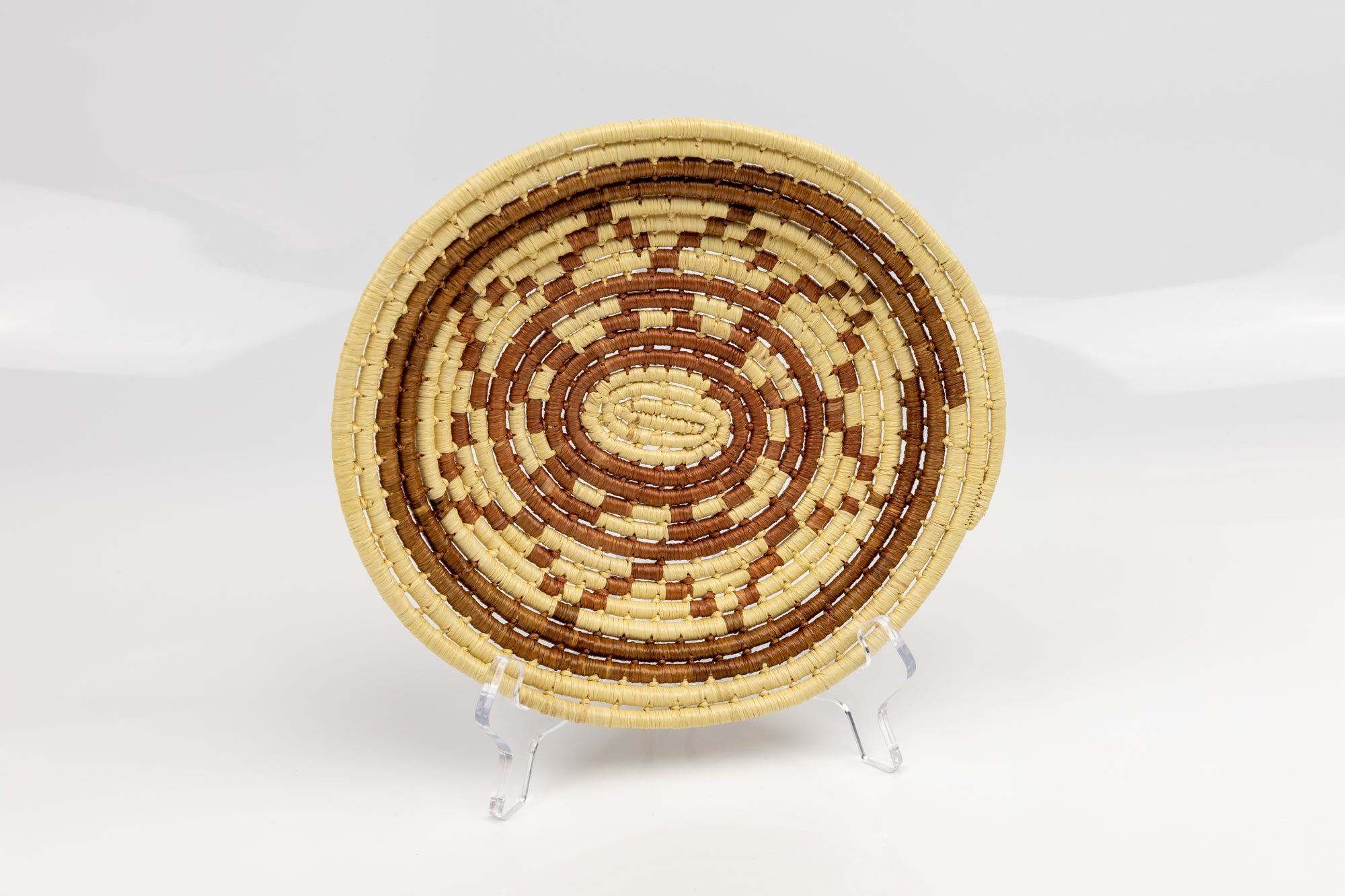 Hand woven  plate basket from Panama. Brown and white colors. Wall decoration. Indigenous artists Panama.