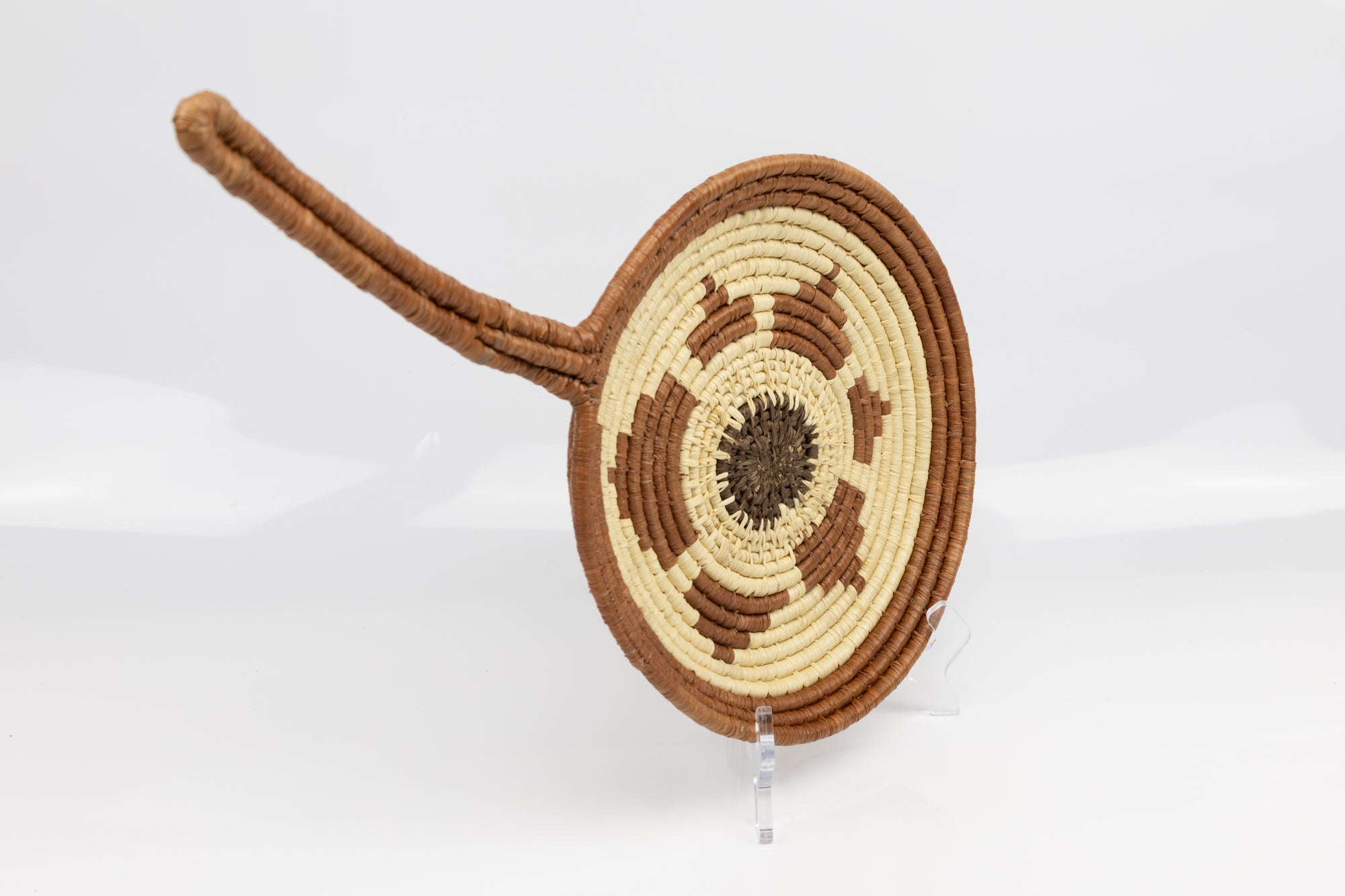 Hand woven plate basket with frying pan design. Palm fiber natural dyes and reed. Woven in Panama.