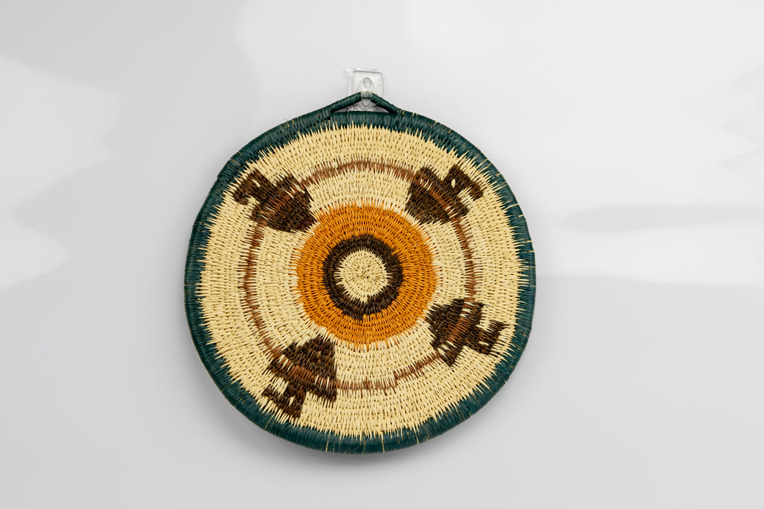 Hand woven plate basket from Panama. blue, gold, brown and white colors. Wall decoration. Indigenous artists Panama.