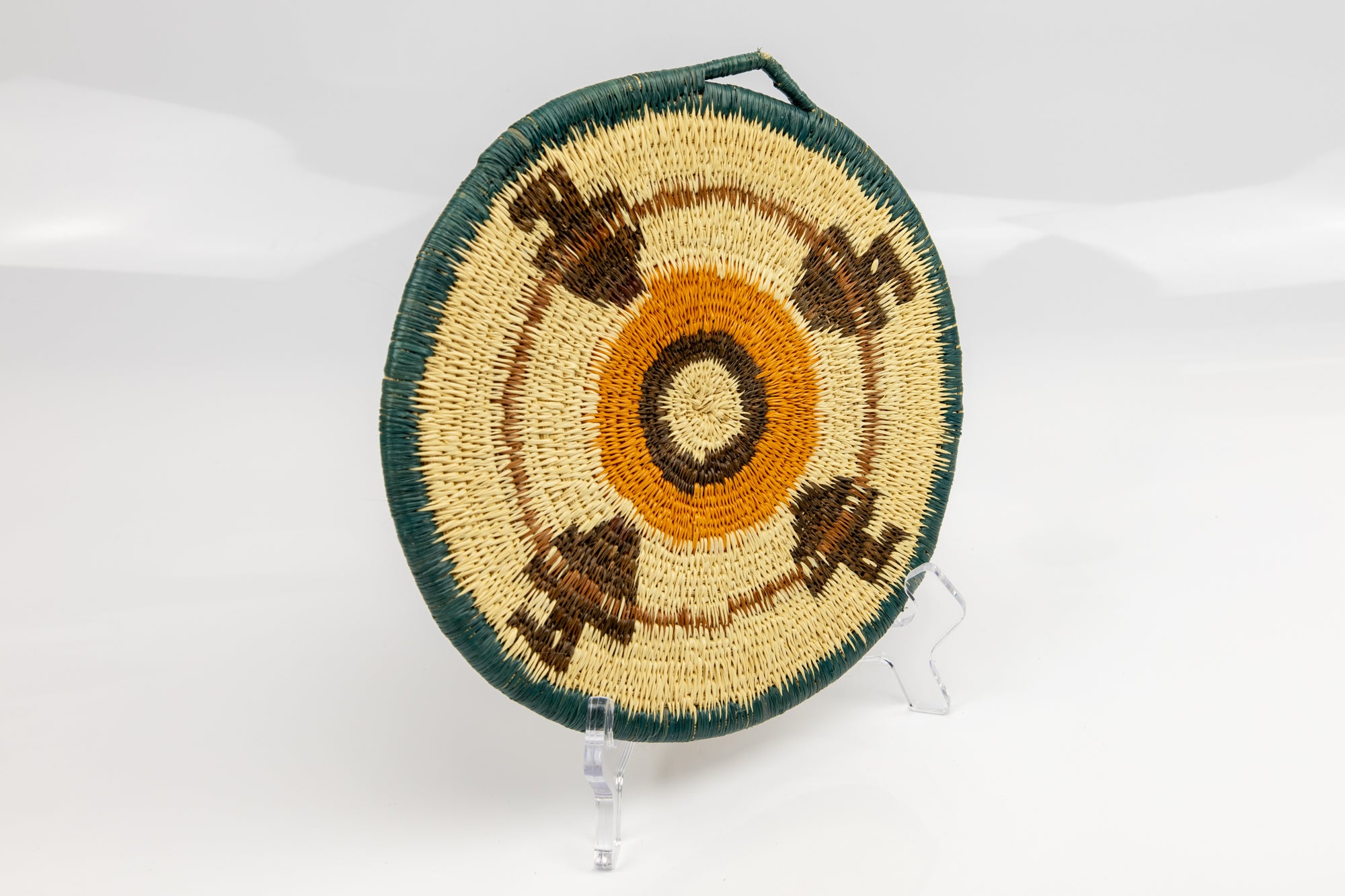 Hand woven plate basket from Panama. blue, gold, brown and white colors. Wall decoration. Indigenous artists Panama.