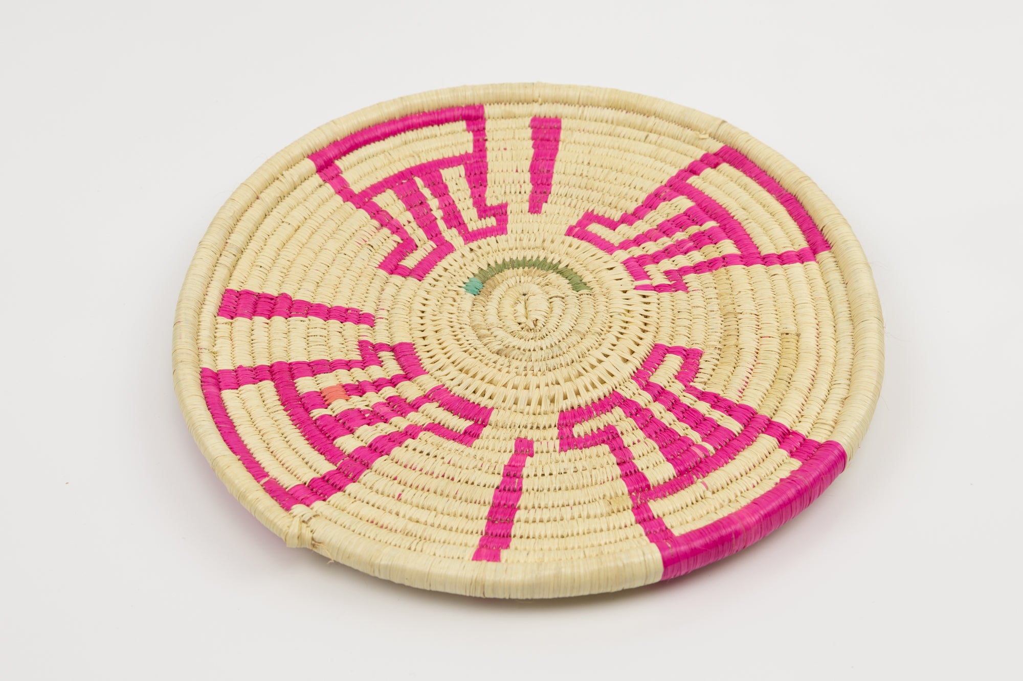 Hand woven plate basket from Panama. Pink and white colors. Wall decoration. Indigenous artists Panama.