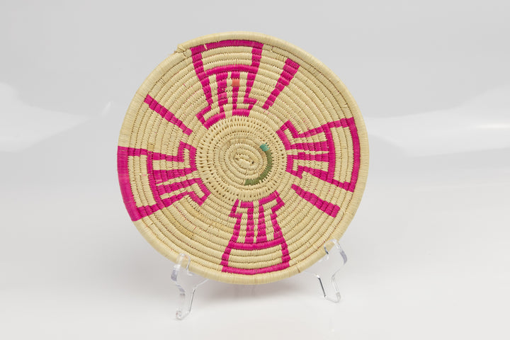 Hand woven plate basket from Panama. Pink and white colors. Wall decoration. Indigenous artists Panama.