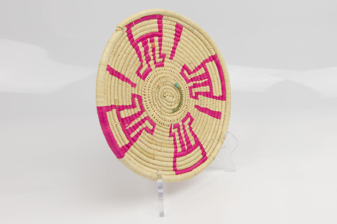 Hand woven plate basket from Panama. Pink and white colors. Wall decoration. Indigenous artists Panama.