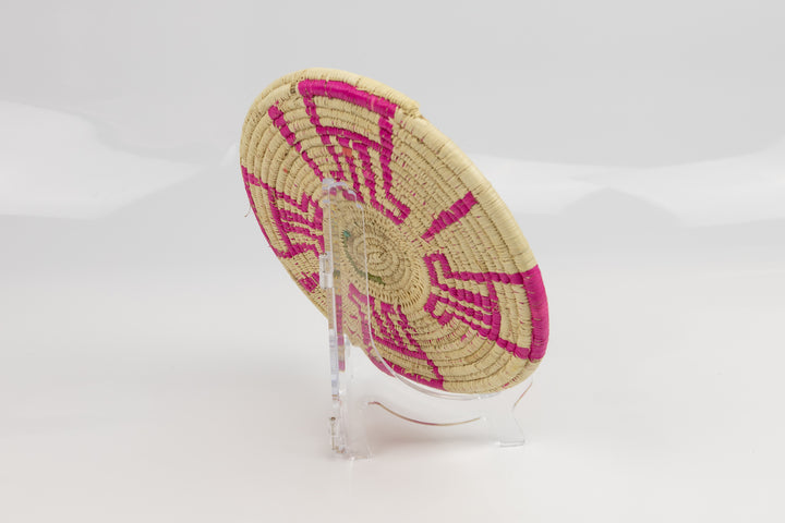 Hand woven plate basket from Panama. Pink and white colors. Wall decoration. Indigenous artists Panama.