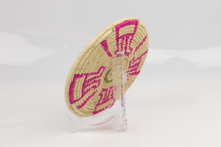 Hand woven plate basket from Panama. Pink and white colors. Wall decoration. Indigenous artists Panama.