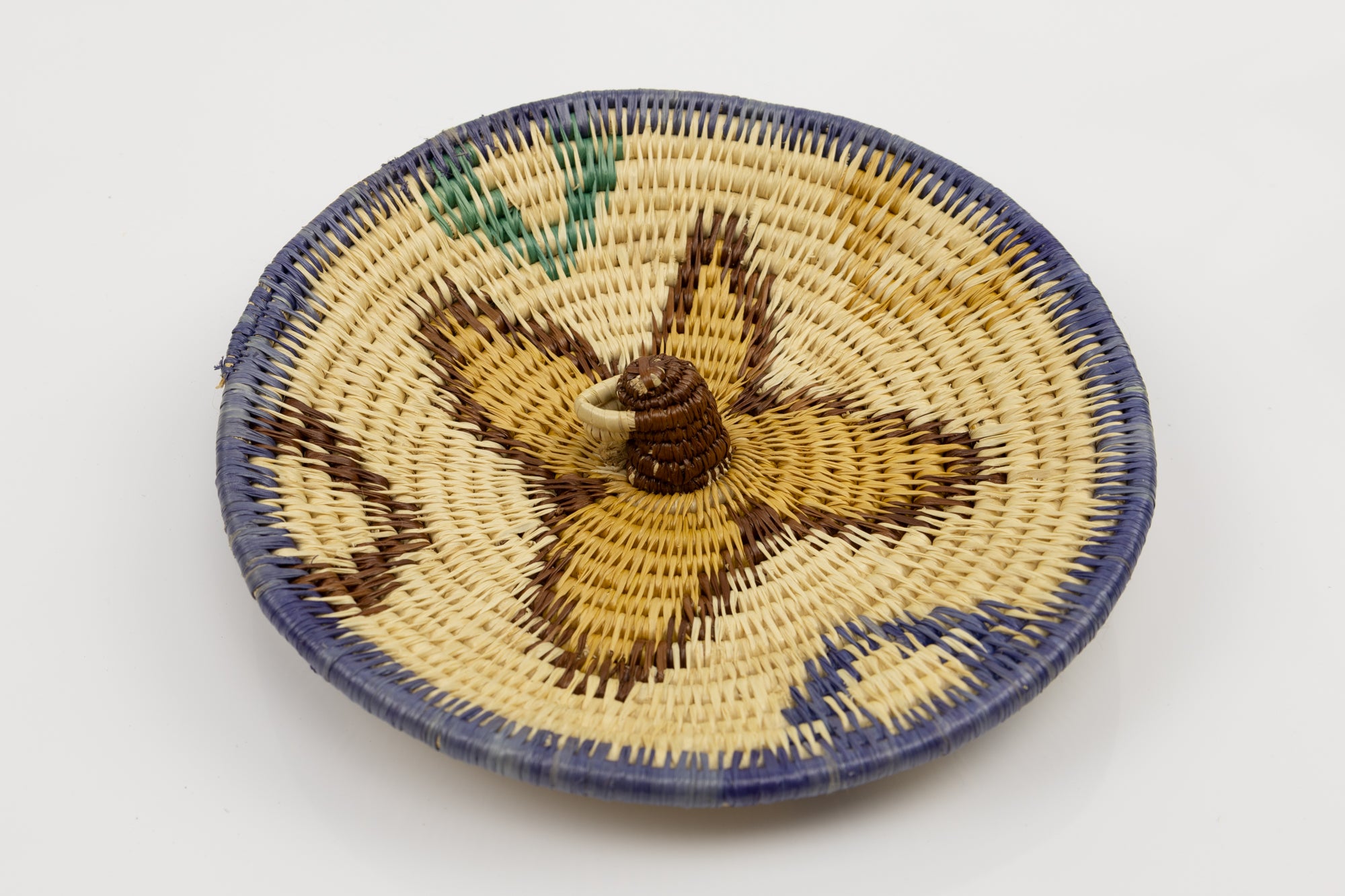 Hand woven plate basket from Panama. Blue, brown, gold and white colors. Wall decoration. Bird head. Indigenous artists Panama.
