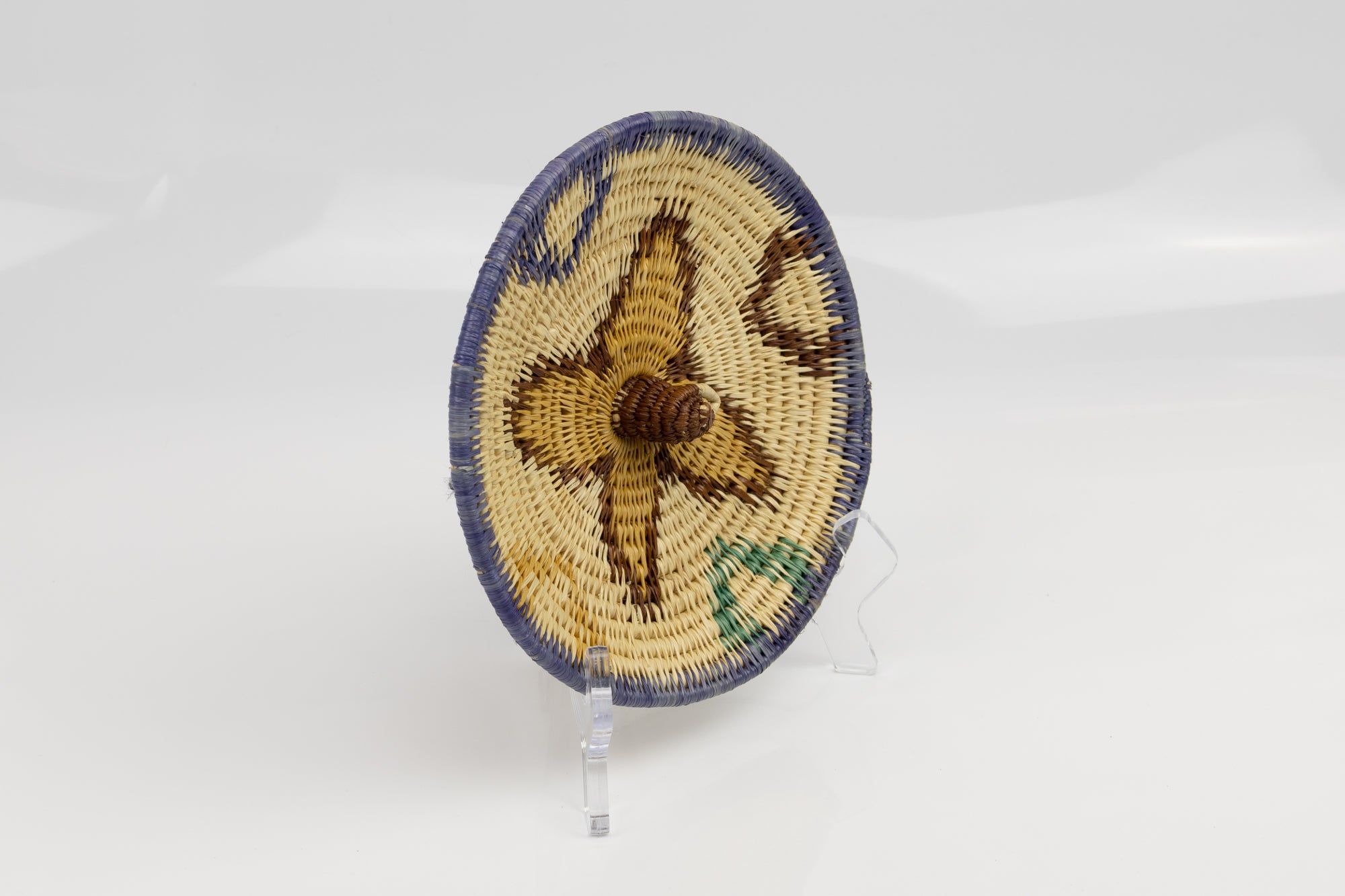 Hand woven plate basket from Panama. Blue, brown, gold and white colors. Wall decoration. Bird head. Indigenous artists Panama.