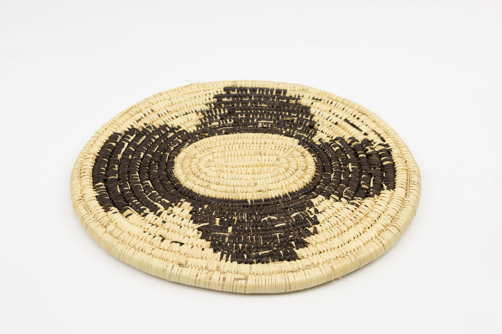 Hand woven plate basket. Black and white colors. 10" diameter and slightly oval in design. 