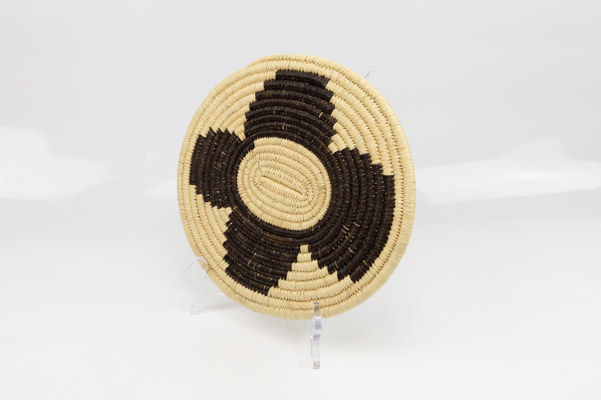 Hand woven plate basket. Black and white colors. 10" diameter and slightly oval in design. 