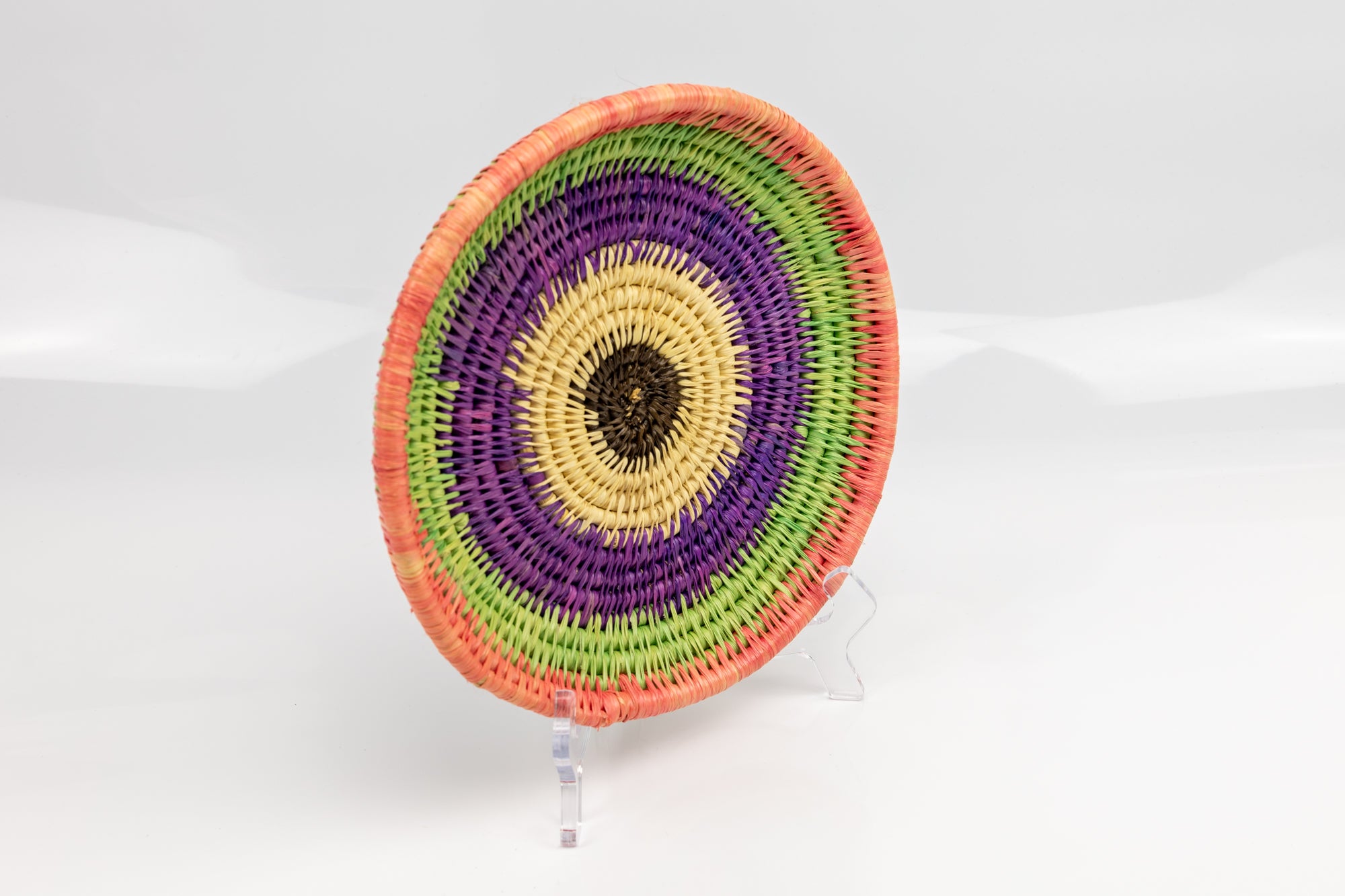 Purple, green and pink. All natural dyes. hand woven plate basket. Made in Panama. 