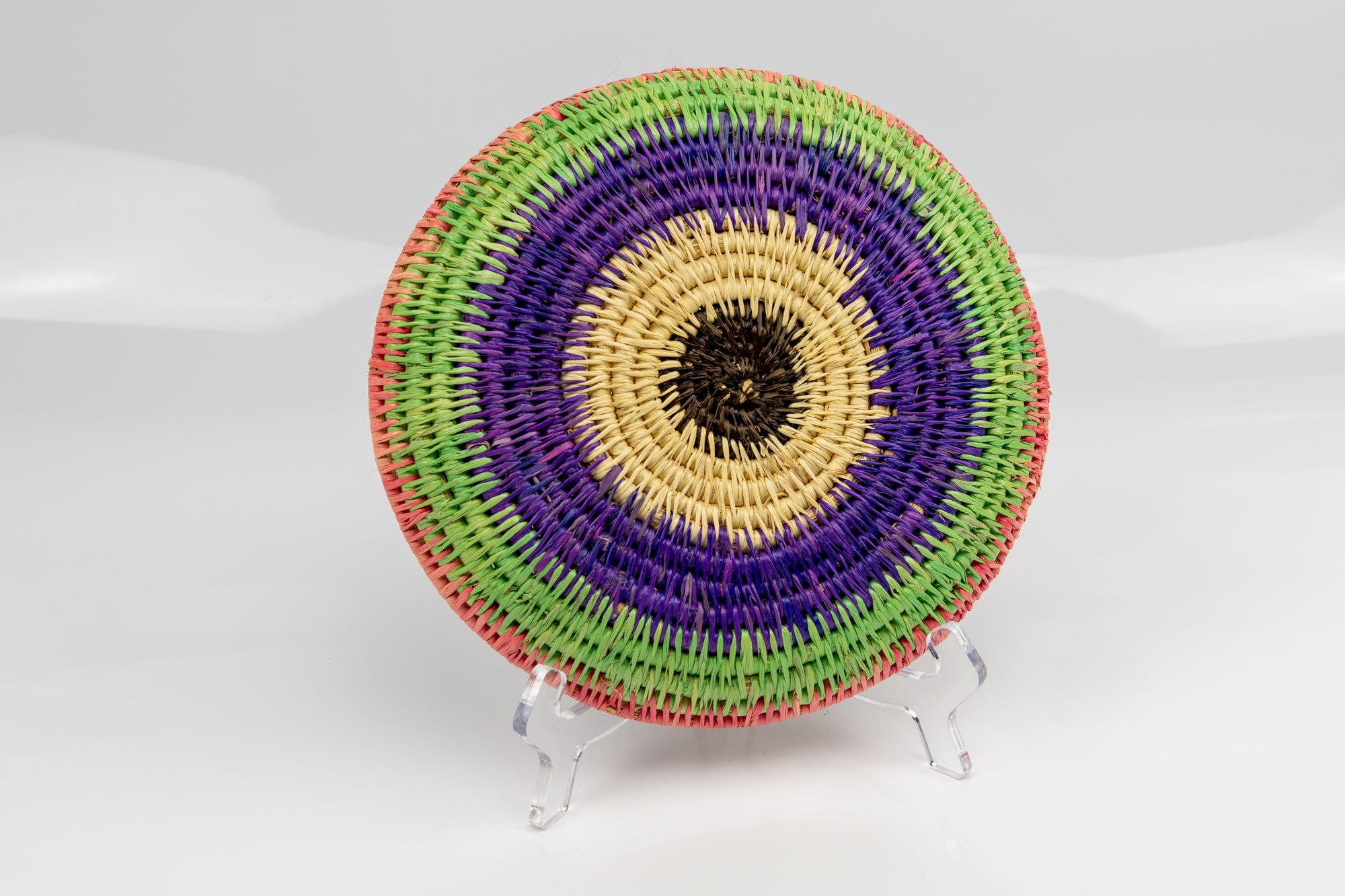 Purple, green and pink. All natural dyes. hand woven plate basket. Made in Panama. 