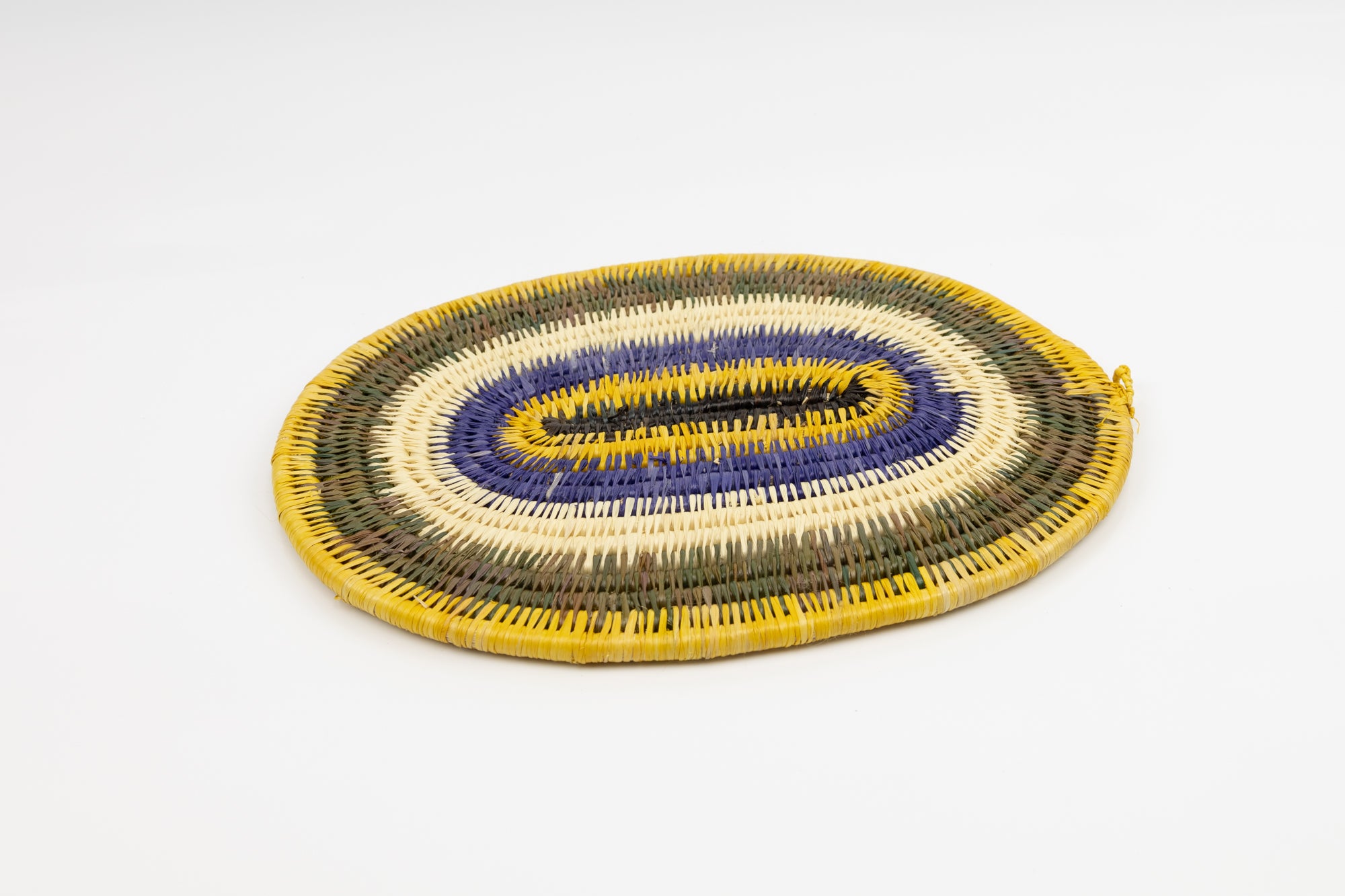 Purple, gold, brown and white. Hand woven plate basket for the wall. Natural dyes. palm fiber. Made in Panama. 