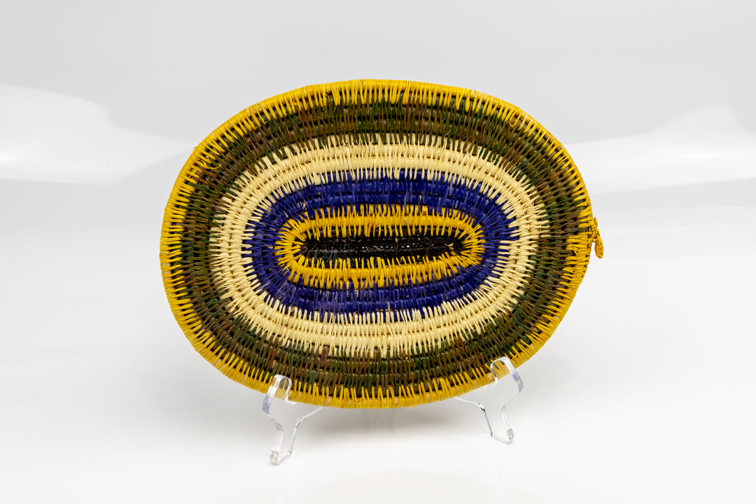 Purple, gold, brown and white. Hand woven plate basket for the wall. Natural dyes. palm fiber. Made in Panama. 