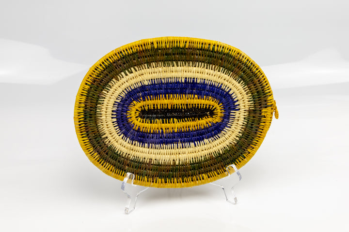 Purple, gold, brown and white. Hand woven plate basket for the wall. Natural dyes. palm fiber. Made in Panama. 