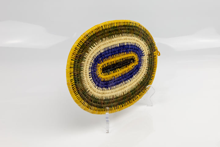 Purple, gold, brown and white. Hand woven plate basket for the wall. Natural dyes. palm fiber. Made in Panama. 