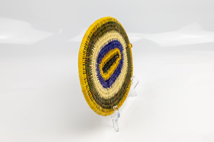 Purple, gold, brown and white. Hand woven plate basket for the wall. Natural dyes. palm fiber. Made in Panama. 