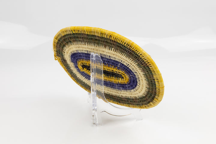 Purple, gold, brown and white. Hand woven plate basket for the wall. Natural dyes. palm fiber. Made in Panama. 