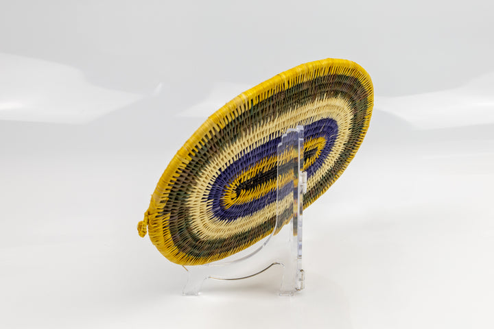 Purple, gold, brown and white. Hand woven plate basket for the wall. Natural dyes. palm fiber. Made in Panama. 