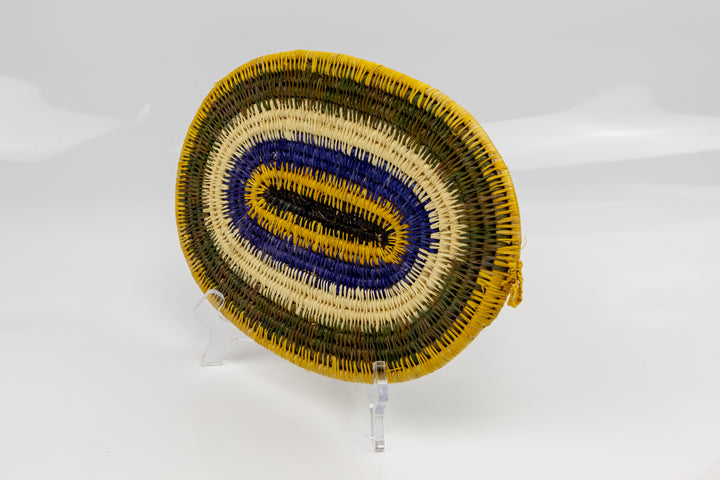 Purple, gold, brown and white. Hand woven plate basket for the wall. Natural dyes. palm fiber. Made in Panama. 