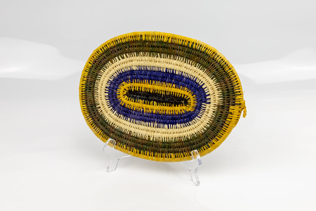 Purple, gold, brown and white. Hand woven plate basket for the wall. Natural dyes. palm fiber. Made in Panama. 