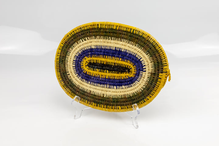 Purple, gold, brown and white. Hand woven plate basket for the wall. Natural dyes. palm fiber. Made in Panama. 
