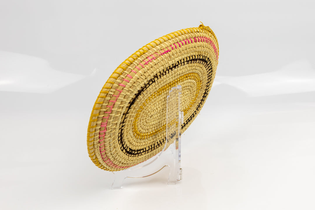 Pink, gold, brown and white. Oval design. Hand woven plate basket. Made in Panama.
