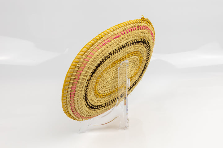 Pink, gold, brown and white. Oval design. Hand woven plate basket. Made in Panama.
