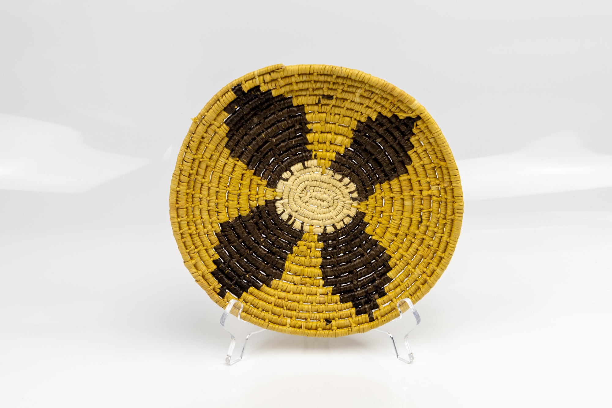 Gold, brown and white. Hand woven plate basket from Panama. Sambu village near Colombia.