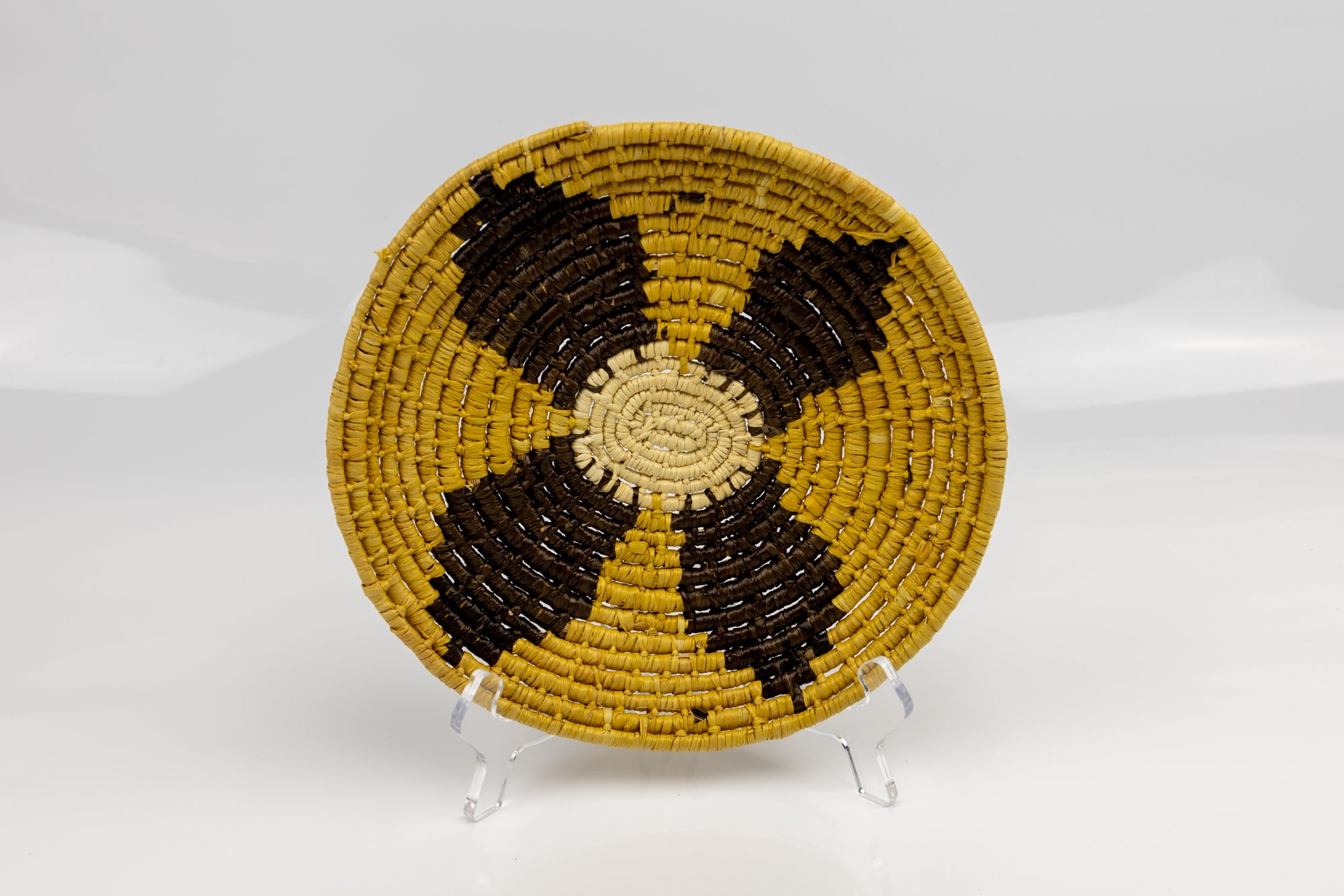 Gold, brown and white. Hand woven plate basket from Panama. Sambu village near Colombia.